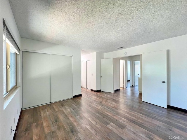 309 Whispering Pine Ln, La Puente, CA 91744 - unfurnished bedroom featuring a textured ceiling and wood finished floors