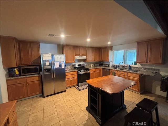 5033 Roundup Rd, Norco, CA 92860 - kitchen with appliances with stainless steel finishes, under cabinet range hood, light tile patterned floors, recessed lighting, and wooden counters