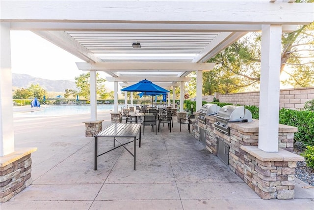3871 Bur Oak Rd, San Bernardino, CA 92407 - view of patio / terrace featuring area for grilling, a pergola, a mountain view, and outdoor dining area