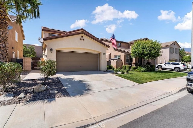 3871 Bur Oak Rd, San Bernardino, CA 92407 - view of front of property with a gate, stucco siding, a garage, and concrete driveway