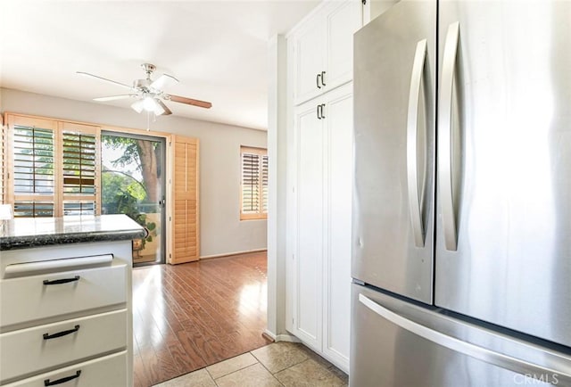 18110 Erik Ct Unit 593, Canyon Country, CA 91387 - kitchen featuring freestanding refrigerator, a ceiling fan, white cabinetry, and light tile patterned flooring