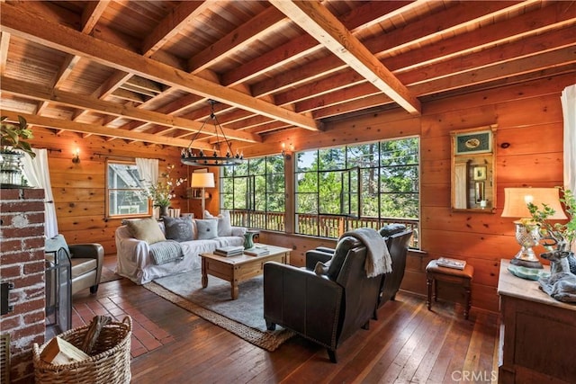 600 Rose Ln, Twin Peaks, CA 92391 - living room with dark wood-style floors, wood walls, a wood ceiling with exposed beams, and a chandelier