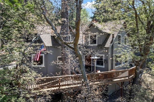 600 Rose Ln, Twin Peaks, CA 92391 - back of house with a wooden deck, a chimney, and roof with shingles