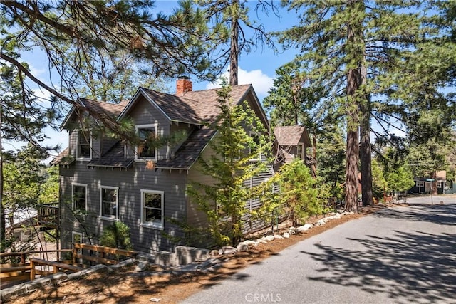 600 Rose Ln, Twin Peaks, CA 92391 - view of side of home with a chimney and roof with shingles