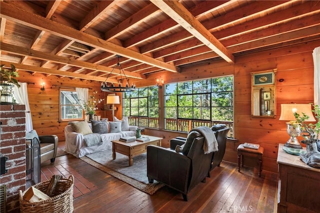 600 Rose Ln, Twin Peaks, CA 92391 - living area featuring wooden walls, dark wood finished floors, a wood ceiling with exposed beams, a wood stove, and a chandelier