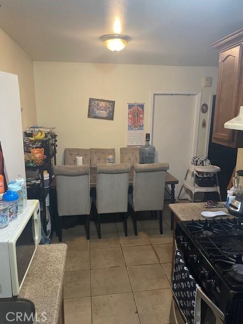 8014 Morton Ave, Los Angeles, CA 90001 - dining area with light tile patterned floors