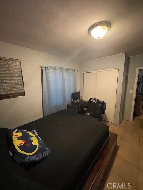8014 Morton Ave, Los Angeles, CA 90001 - bedroom featuring light tile patterned floors and a closet