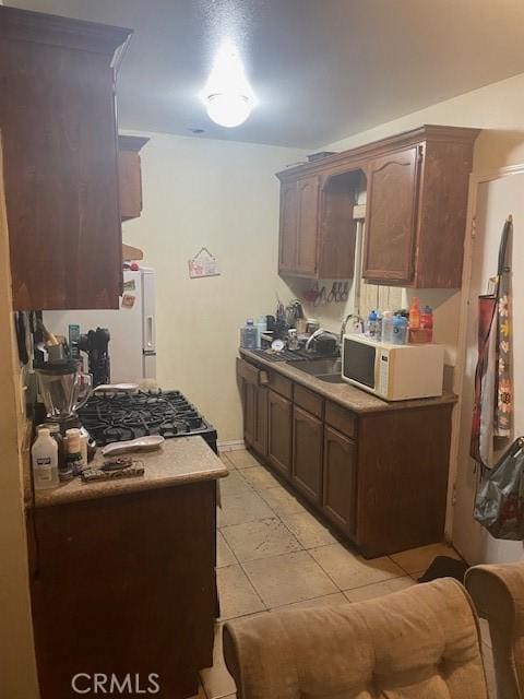 8014 Morton Ave, Los Angeles, CA 90001 - kitchen with white appliances, light tile patterned floors, and light countertops