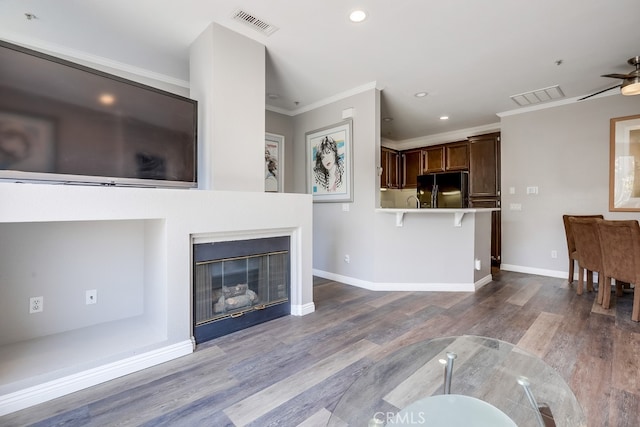 376 Gullotti Pl, Placentia, CA 92870 - unfurnished living room with a ceiling fan, wood finished floors, crown molding, recessed lighting, and a glass covered fireplace