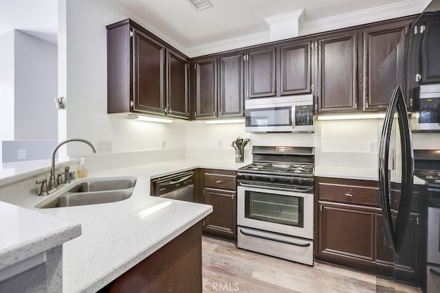 376 Gullotti Pl, Placentia, CA 92870 - kitchen with appliances with stainless steel finishes, ornamental molding, light wood finished floors, light stone counters, and dark brown cabinetry