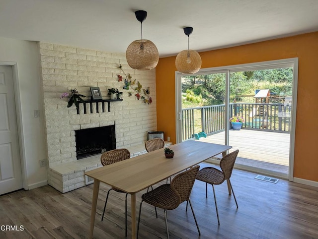 21613 Mountain Dr, Tehachapi, CA 93561 - dining space with wood finished floors and a brick fireplace