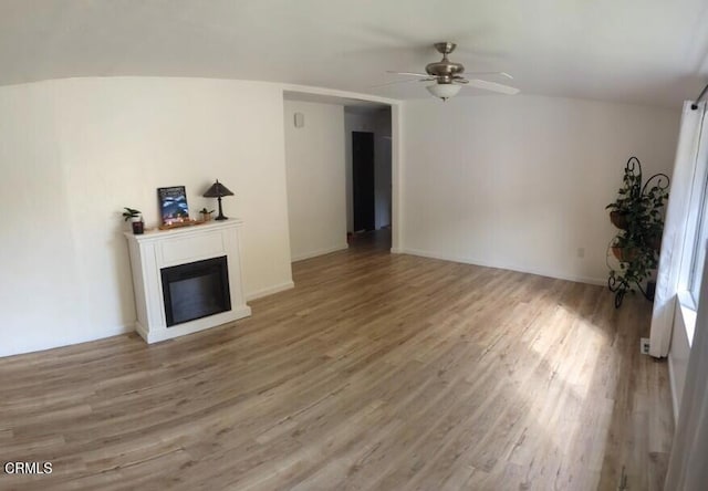 21613 Mountain Dr, Tehachapi, CA 93561 - unfurnished living room with ceiling fan, wood finished floors, and a glass covered fireplace