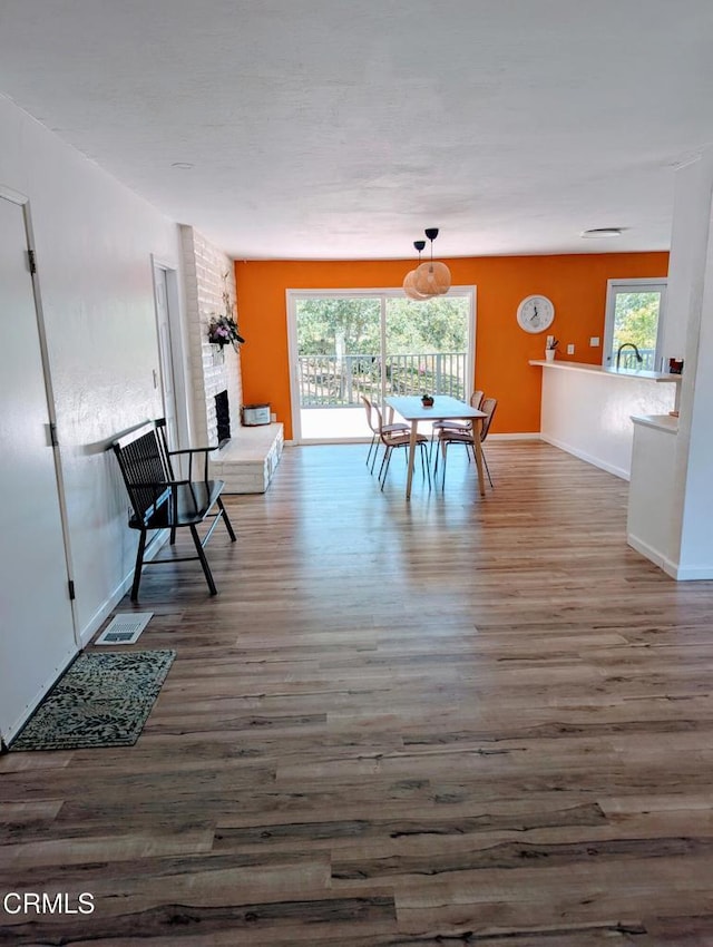 21613 Mountain Dr, Tehachapi, CA 93561 - dining area featuring wood finished floors, plenty of natural light, and a fireplace