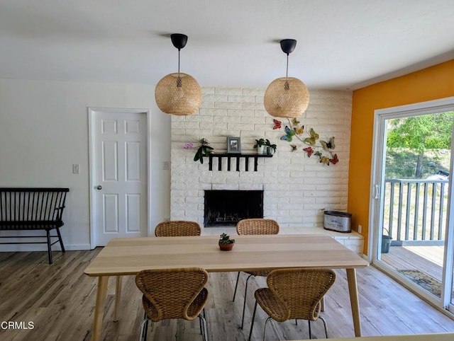 21613 Mountain Dr, Tehachapi, CA 93561 - dining area featuring wood finished floors and a brick fireplace