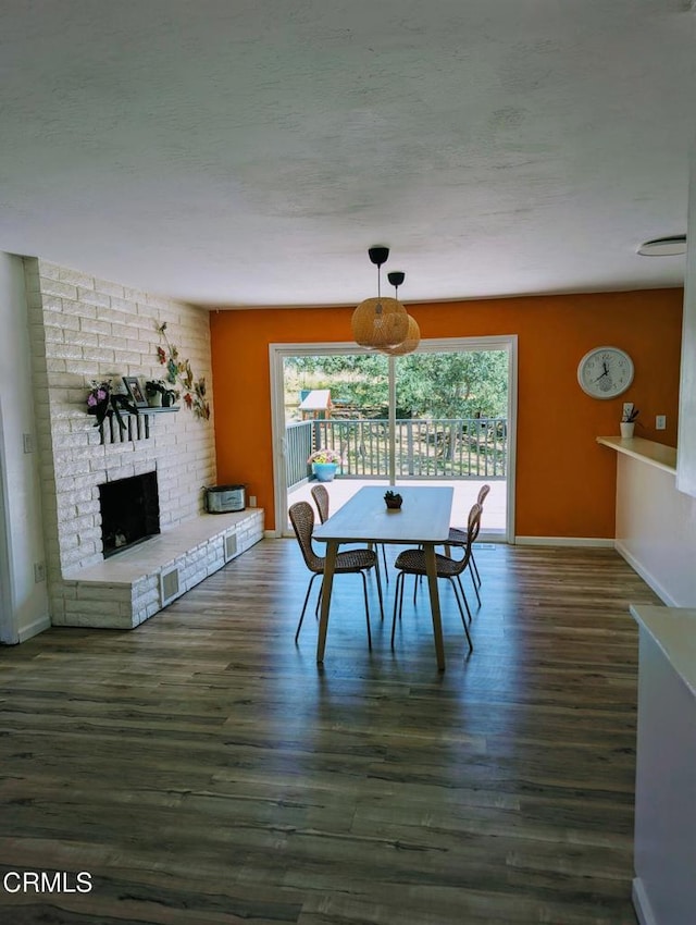 21613 Mountain Dr, Tehachapi, CA 93561 - dining area with wood finished floors, a fireplace, and a textured ceiling