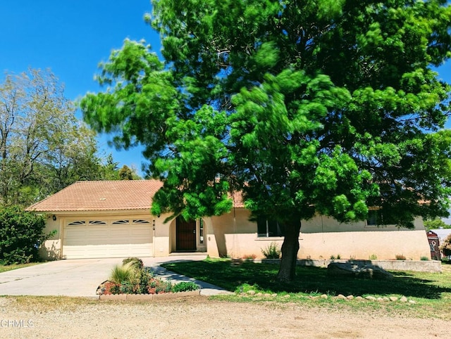 21613 Mountain Dr, Tehachapi, CA 93561 - view of front facade with stucco siding, a garage, driveway, and a tiled roof