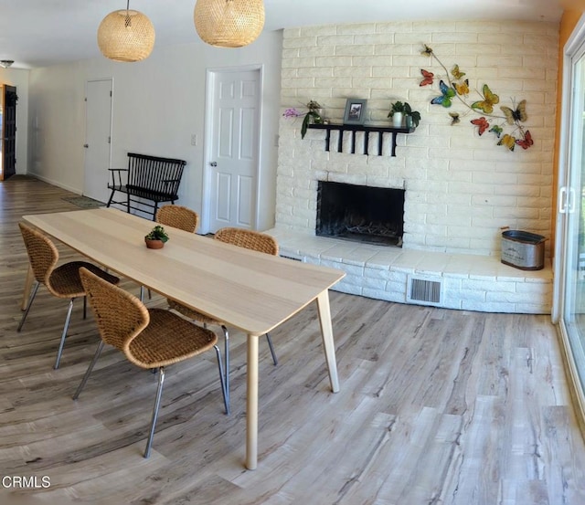 21613 Mountain Dr, Tehachapi, CA 93561 - dining space featuring wood finished floors and a fireplace