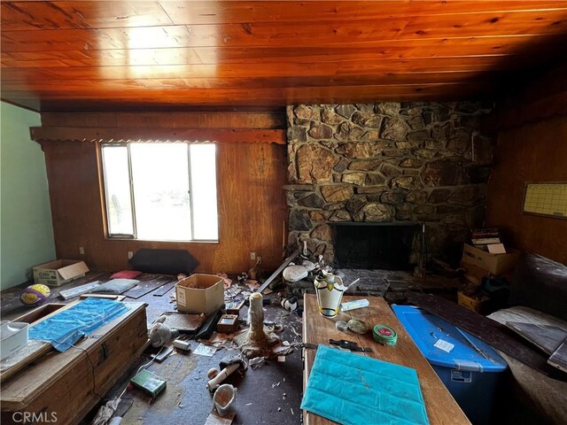 12449 6th St, Yucaipa, CA 92399 - living room with wooden ceiling, a stone fireplace, and wooden walls