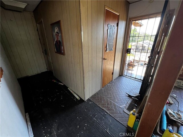 12449 6th St, Yucaipa, CA 92399 - foyer entrance featuring wood walls and brick floors