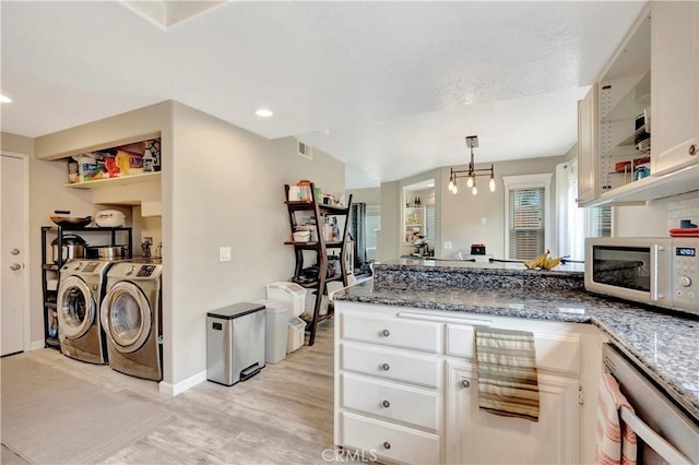 30042 Oceanus, Laguna Niguel, CA 92677 - kitchen featuring white microwave, washer and dryer, a peninsula, dishwasher, and white cabinetry