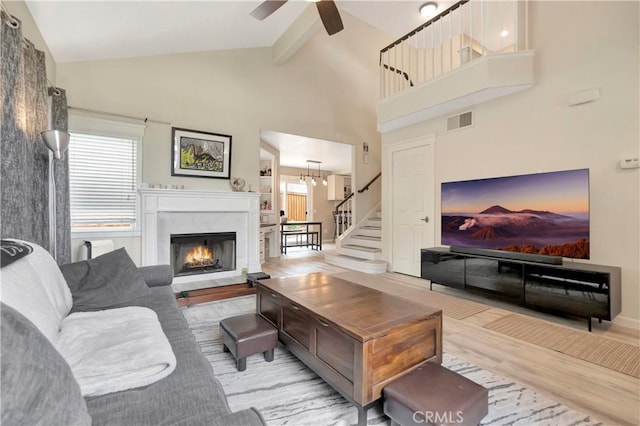 30042 Oceanus, Laguna Niguel, CA 92677 - living area featuring stairway, wood finished floors, ceiling fan, a fireplace, and high vaulted ceiling