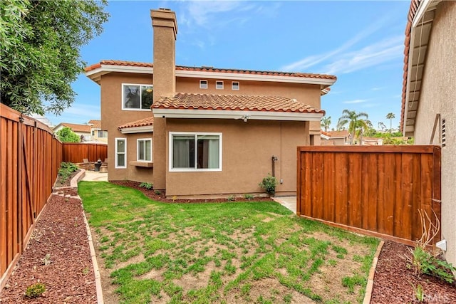 30042 Oceanus, Laguna Niguel, CA 92677 - back of house with a fenced backyard, stucco siding, a tiled roof, and a chimney