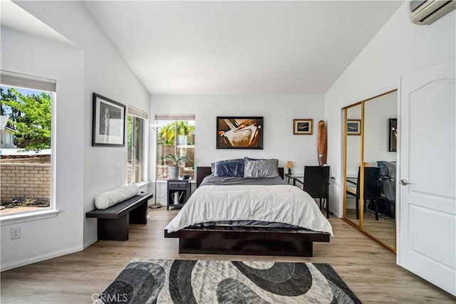 36536 Jenna Ln, Palmdale, CA 93550 - bedroom with vaulted ceiling, a wall unit AC, wood finished floors, and a closet