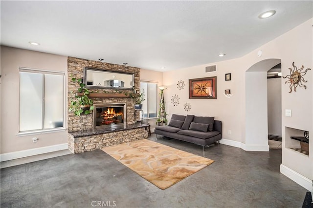 36536 Jenna Ln, Palmdale, CA 93550 - living area featuring arched walkways, a fireplace, recessed lighting, and concrete floors