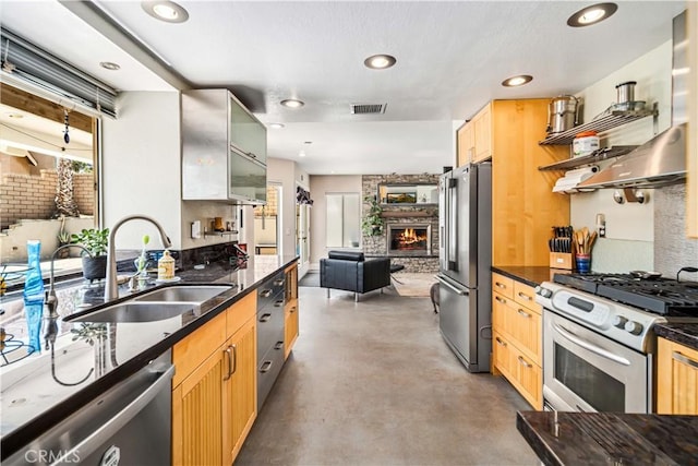 36536 Jenna Ln, Palmdale, CA 93550 - kitchen with stainless steel appliances, concrete flooring, ventilation hood, a stone fireplace, and glass insert cabinets