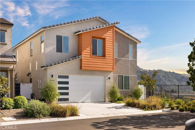 3173 Ivy Way, Rancho Mission Viejo, CA 92694 - view of front of home with stucco siding, a garage, a mountain view, and driveway
