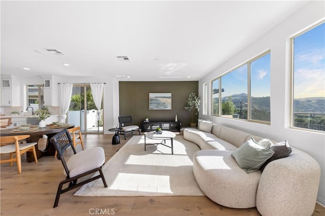 3173 Ivy Way, Rancho Mission Viejo, CA 92694 - living area with light wood finished floors, recessed lighting, and a mountain view