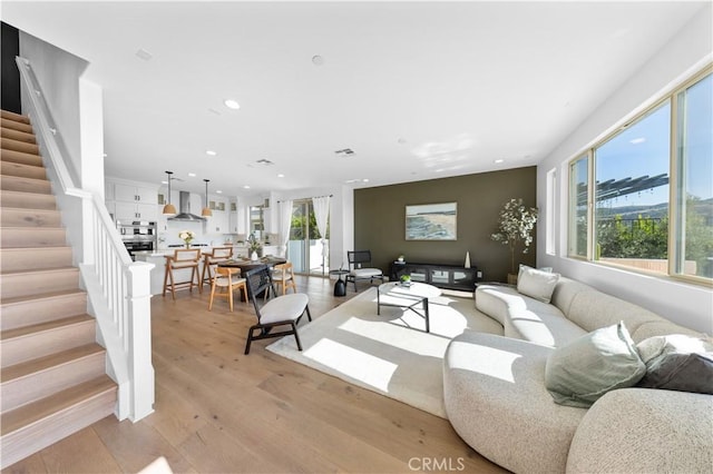 3173 Ivy Way, Rancho Mission Viejo, CA 92694 - living room featuring plenty of natural light, stairs, recessed lighting, and light wood-style flooring