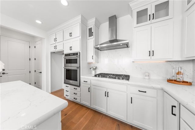 3173 Ivy Way, Rancho Mission Viejo, CA 92694 - kitchen with wall chimney exhaust hood, stainless steel appliances, recessed lighting, white cabinetry, and tasteful backsplash