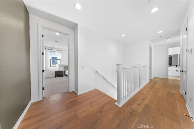 3173 Ivy Way, Rancho Mission Viejo, CA 92694 - hall with an upstairs landing, light wood finished floors, and recessed lighting
