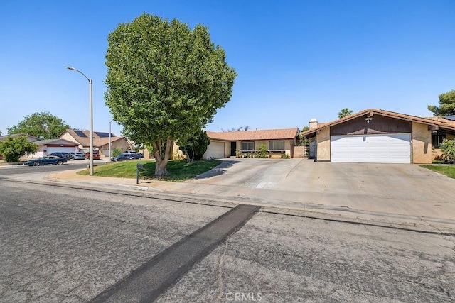 44668 13th St E, Lancaster, CA 93535 - view of front of house with a garage, concrete driveway, and stucco siding