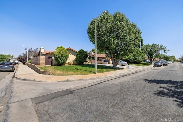 44668 13th St E, Lancaster, CA 93535 - view of asphalt street featuring street lighting, curbs, and sidewalks