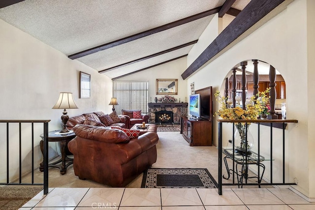 44668 13th St E, Lancaster, CA 93535 - carpeted living room with a textured ceiling, a stone fireplace, and arched walkways