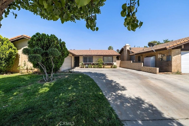 44668 13th St E, Lancaster, CA 93535 - ranch-style home featuring concrete driveway, a tile roof, a front lawn, stucco siding, and an attached garage