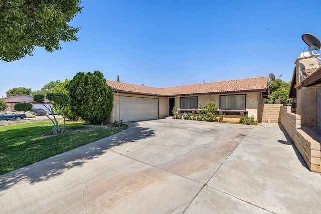 44668 13th St E, Lancaster, CA 93535 - ranch-style home featuring a tile roof, stucco siding, an attached garage, and concrete driveway
