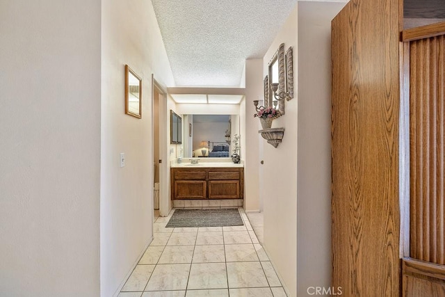 44668 13th St E, Lancaster, CA 93535 - hallway featuring a textured ceiling and light marble finish floors