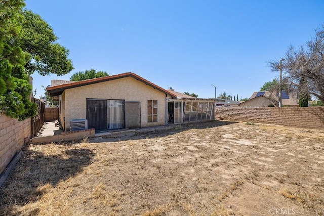 44668 13th St E, Lancaster, CA 93535 - rear view of property with stucco siding and a fenced backyard