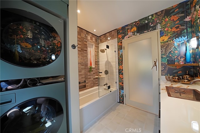 1525 N Hayworth Ave Unit 304, Los Angeles, CA 90046 - bathroom featuring stacked washer / dryer, bathing tub / shower combination, and tile patterned floors