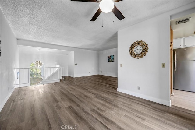 13303 Waco St Unit 32, Baldwin Park, CA 91706 - unfurnished living room with a ceiling fan, wood finished floors, and a textured ceiling