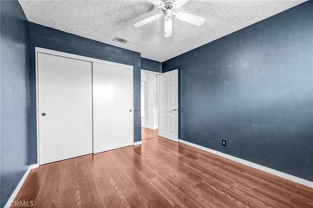13303 Waco St Unit 32, Baldwin Park, CA 91706 - unfurnished bedroom with wood finished floors, a textured ceiling, a closet, and a ceiling fan