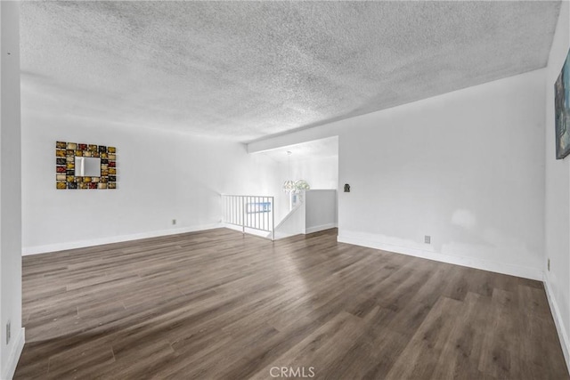 13303 Waco St Unit 32, Baldwin Park, CA 91706 - empty room with a textured ceiling, wood finished floors, and a chandelier