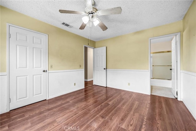 13303 Waco St Unit 32, Baldwin Park, CA 91706 - unfurnished bedroom featuring wood finished floors, a textured ceiling, ensuite bath, and ceiling fan