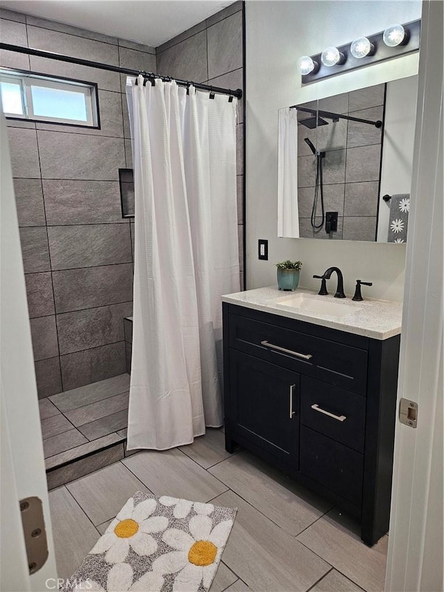8463 California Ave, Riverside, CA 92504 - bathroom with a tile shower, vanity, and wood finish floors