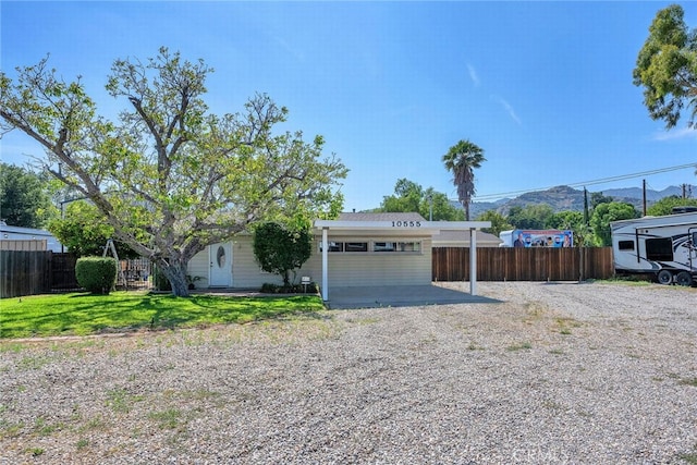 10555 Topanga Canyon Blvd, Chatsworth, CA 91311 - view of front facade with gravel driveway and a mountain view