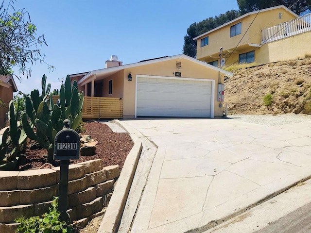 1230 Ramona Ave, Spring Valley, CA 91977 - view of front of property with stucco siding, concrete driveway, a garage, and a chimney