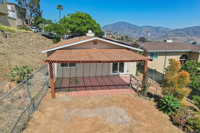 1230 Ramona Ave, Spring Valley, CA 91977 - rear view of house featuring a pergola, a mountain view, stucco siding, and a patio